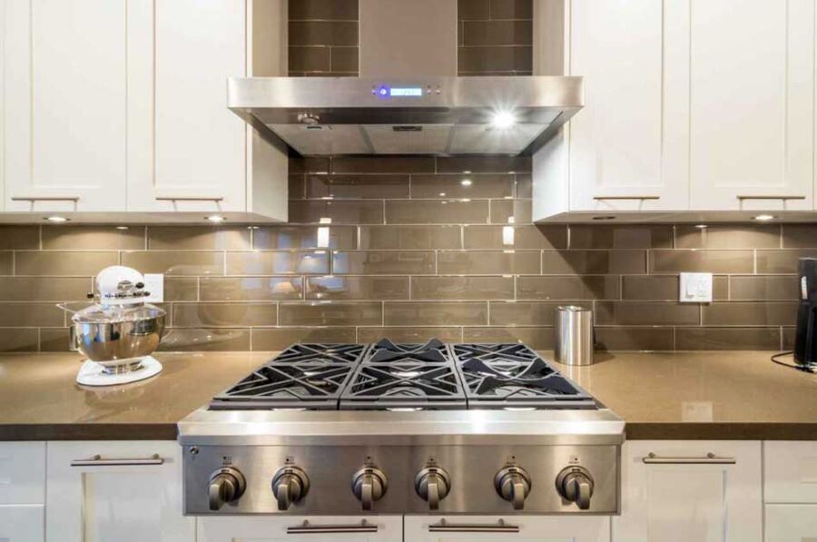 Pro Range Top, Walnut Creek — A stainless pro-style range top dropped into stone, sealed at the perimeter, gas leak-tested and lit burner by burner before sign-off.