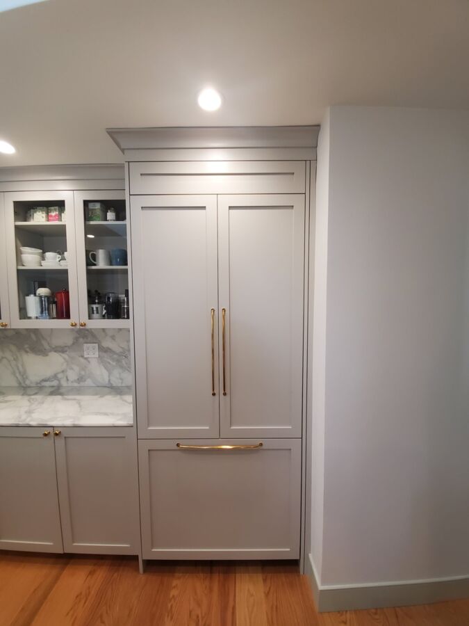 Panel-Ready Built-In, Burlingame — A panel-ready built-in refrigerator anchored, levelled and fitted with custom overlay panels so it disappears into the cabinetry completely.