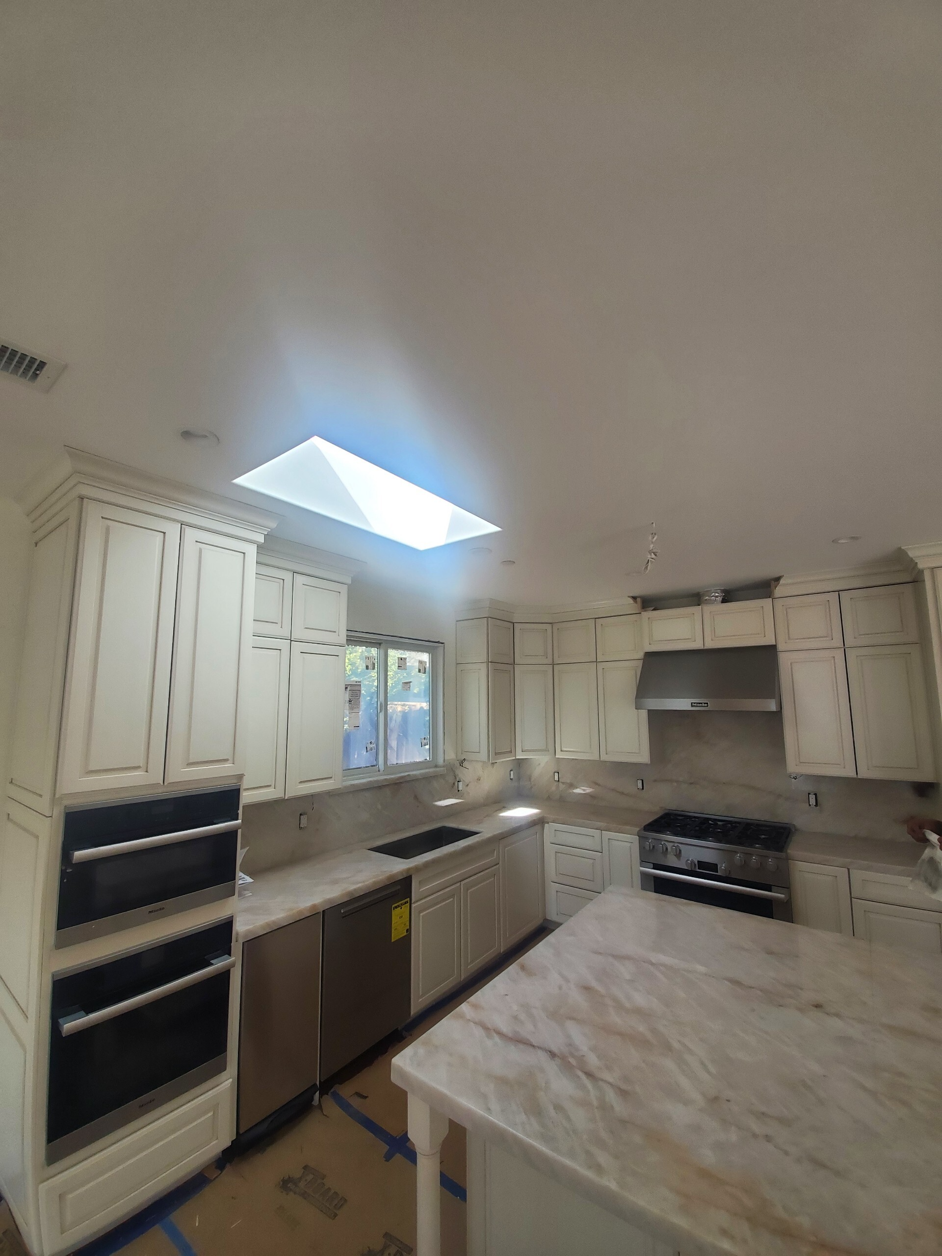 Double wall ovens being set into cabinetry during an appliance installation